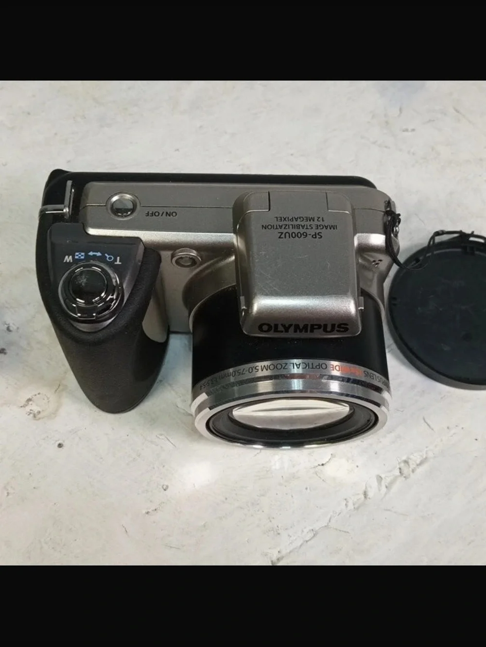 Olympus Silver Digital Camera with Black Grip and Lens Cap